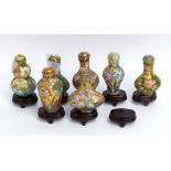 Seven modern Chinese enamel decorated snuff bottles and stands.