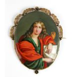 A porcelain plaque of a figure reading, set in a filigree gilt metal mount, length 12cm Additional