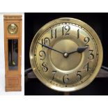 A mid-20th century oak longcase clock, the circular brass dial set with Arabic numerals and with