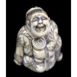 A late 18th century Japanese carved ivory netsuke of a seated foreigner holding a stem cup, height