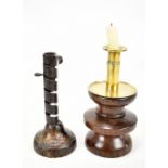 An 18th century wrought iron adjustable candle holder with wrythen twisted central section raised on