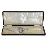 A cased Edward VII hallmarked silver Art Nouveau cake slice with carved ivory handle and pierced