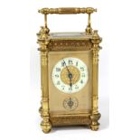 A late 19th century brass cased carriage clock, the porcelain dial set with Arabic numerals and