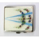 A George V hallmarked silver and enamel decorated cigarette case of rounded rectangular form,