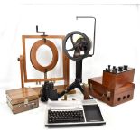 A group of scientific instruments including a wrought iron and brass apparatus to measure the