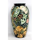 MOORCROFT; a navy ground tubeline decorated 'Golden Lily' pattern vase with WM monogram, impressed