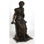 A late 19th century French bronze figure of a seated woman wearing a robe and holding a dagger,