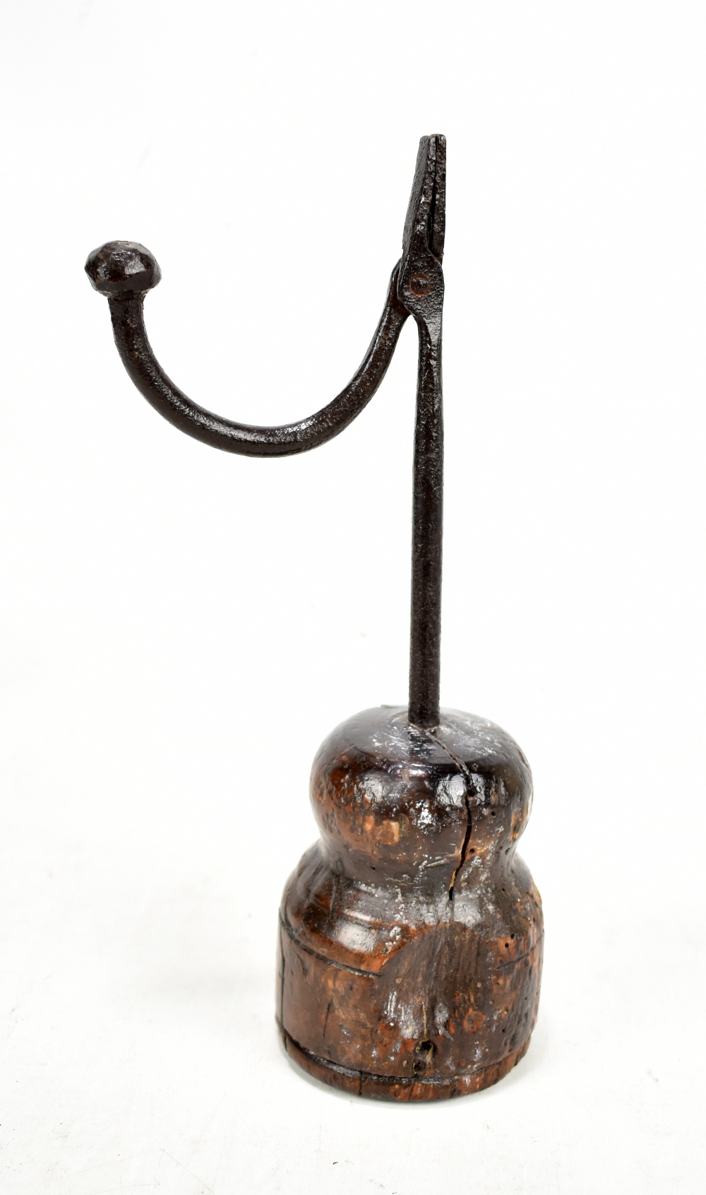 An 18th century wrought iron rush light with turned wooden base, height 28cm.