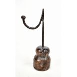 An 18th century wrought iron rush light with turned wooden base, height 28cm.