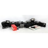 A group of cameras and related equipment including Asahi Pentax SPII, Olympus OM10, Sigma DL Zoom