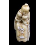 A early 19th century Japanese carved sperm whale tooth netsuke of Seiobo, height 5cm.Additional