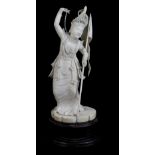 A late 19th century Indian carved ivory figure of a female dancer holding a flag and wearing