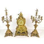 A decorative gilt metal mantel clock with a pair of scrolling candelabra, height of clock 55cm.