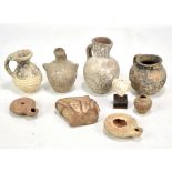 A group of Roman pottery including two oil lamps, small figurative bust, various vessels etc (9).