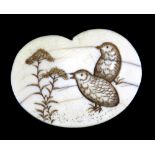 A 19th century Japanese carved ivory netsuke of a manju and carved with two quail beside branches,