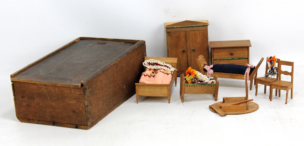 A set of 19th century German dolls' house wooden furniture including a wardrobe, crib etc, circa