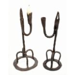 Two 18th century wrought iron rush lights with integral iron bases, heights 29cm and 27.5cm (2).