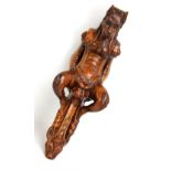 An unusual late 19th century carved walnut capital modelled as a mythical beast, length 40cm.