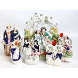 A group of six 19th century Staffordshire figures and figure groups including two spill vases and