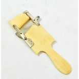 A 19th century ivory cucumber slicer, length 21.5cm.Additional InformationOne of the raised brackets