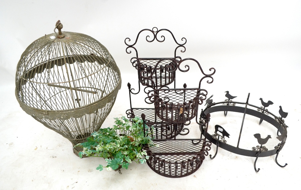 A bird cage in the form of a hot air balloon, a pair of small planters and a hanging pan rack