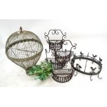 A bird cage in the form of a hot air balloon, a pair of small planters and a hanging pan rack