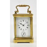 A French brass-cased miniature carriage clock, the circular dial set with Roman numerals and