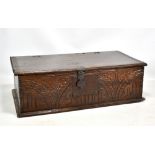 A late 17th century oak Bible box with chip carved side mouldings and carved front panel with