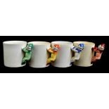 CLARICE CLIFF; four 'Pixie Ware' mugs with handles modelled as pixies in green, blue, red and orange