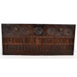 A late 17th century carved oak panel, formerly the front of a coffer, 88 x 38.5cm.