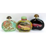 Three modern Chinese snuff bottles, one decorated with a cougar, one a Ferrari and one a nude figure