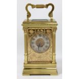 REID & SONS; a late 19th century French brass cased carriage clock, the silvered circular dial set