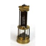 A Thomas & Williams of Aberdare safety lamp with gauze and part glass central section to brass base,