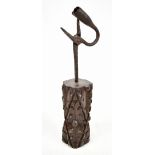 An 18th century wrought iron rush light mounted in a carved oak base, height 28cm (base possibly