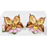 HEREND; a pair of hand painted figures of butterflies perched on flowers, both marked to base,