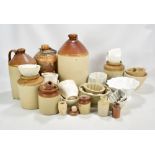 A collection of stoneware including flagons, jelly moulds and small jars.