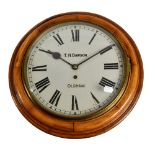 A late nineteenth century oak circular single fusée wall clock with painted dial inscribed "T.H.