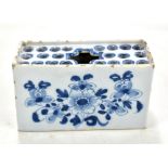 An 18th century Liverpool Delft flower brick painted with floral sprays, length 12.5cm.Additional