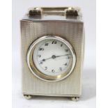 GOLDSMITHS & SILVERSMITHS CO LTD; a George V hallmarked silver carriage timepiece with engine turned