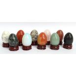 A group of ten contemporary specimen hardstone polished eggs, including gold stone, red jasper and