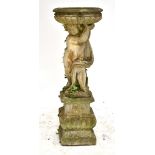 A large reconstituted garden ornament with cherub holding aloft a bowl, height 141cm.