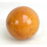 A large fruitwood ball, diameter 16cm contained within a modern box.