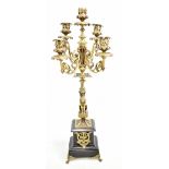 An early 20th century French brass five light candelabrum with foliate scroll branches and campana