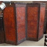 A circa 1900 Japanese three fold wooden screen, with lotus and floral sprays, purported to be