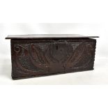 An early 18th century oak bible box with carved decoration to the front panel and inscribed with