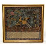 An 18th century Chinese embroidered rank badge decorated with an exotic bird, 27 x 29cm, framed