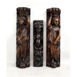 A pair of early 19th century oak carvings, each depicting a robed female figure with basket of fruit