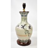 A Japanese celadon glazed baluster vase with flared neck, painted with birds amongst bamboo branches