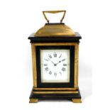 A late 19th/early 20th century French gilt and ebonised wood mantel clock, the enamelled circular