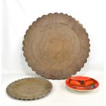 POOLE; an abstract design charger, diameter 27cm, and two brass trays (3).